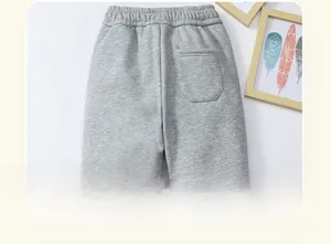 Detail view of children's thick grey joggers showing elastic waist and back patch pocket