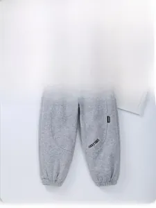 Detail view of gray fleece jogger pants for kids with LUCKY FANS print and drawstring