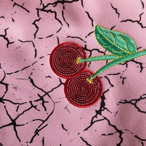Girl's fleece sweatshirt in pink with detailed cherry embroidery and marble print texture