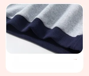 Dettaglio dell'orlo elastico a coste su maglione per bambini con cuciture a contrasto