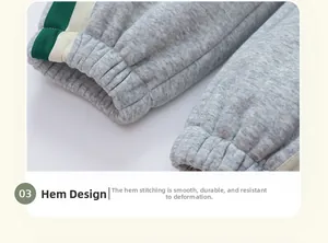 Detail of ribbed cuffs on gray fleece trousers with green and beige striped side tape