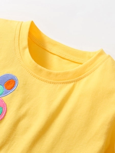 Girl's yellow cotton summer dress featuring a soft round neckline and floral embroidery