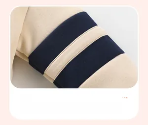 Detail shot of the shoulder seam on a fleece sweatshirt with navy striped applique