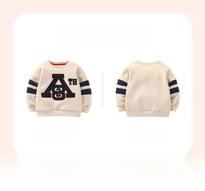 Detail view of cream kids sweatshirt with ATH applique and blue stripes on sleeves
