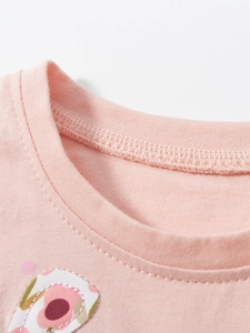 Pink cotton girls' dress featuring a ribbed neckline and delicate floral embroidery