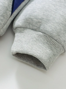 Close-up of grey fleece-lined sleeve with ribbed cuffs and blue side paneling