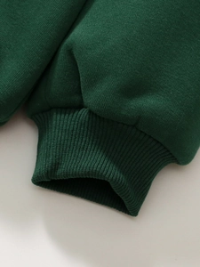 Thick forest green girls' sweatshirt with ribbed cuffs and warm fleece lining