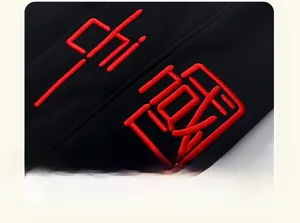 Detailed view of red 3D embroidery on black fleece lining casual trousers for boys