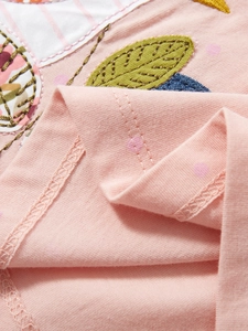 Pink cotton girls dress featuring cartoon embroidery and soft polka dot knit fabric