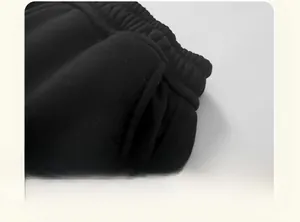 Close-up of durable reinforced stitching on children's black winter fleece trousers