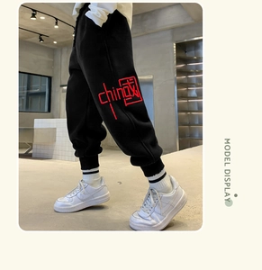 Detail of red China embroidery on thick black warm fleece joggers for boys