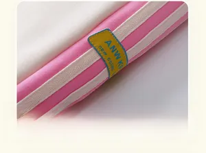 Detailed macro shot of high-quality cotton fabric with yellow leather brand patch and stripes