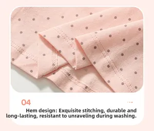 Detail of double-needle stitching on pink polka dot cotton hem for girls' summer set