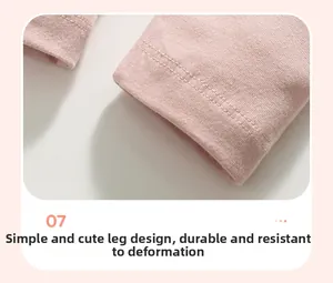 Detail of baby pink knit cotton trousers showing durable double-stitched hem and seams