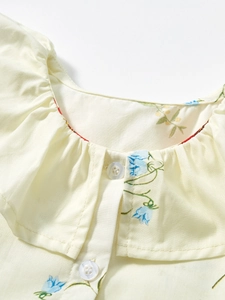 Girls cotton floral summer dress with ruffled collar and button detail in light yellow
