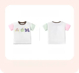 Close-up of girl's cotton T-shirt featuring cartoon cat, apple, and butterfly prints