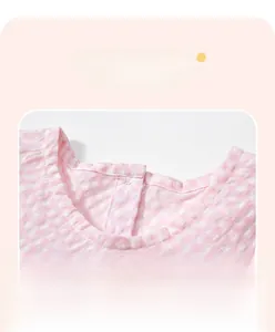 Détail d'une robe en seersucker à carreaux roses et blancs avec col rond et finitions de couture
