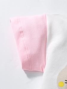 Close-up of pink ribbed cuffs and white cotton fabric on a girl's short-sleeved T-shirt