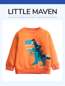 Detail of orange cotton sweatshirt featuring blue dinosaur patch and ribbed sleeve cuffs