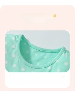 Detail of mint green polka dot cotton neckline with ribbed trim and durable stitching