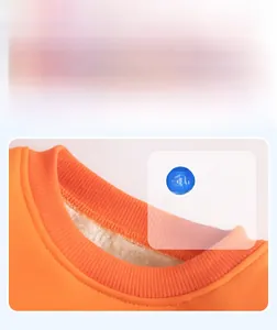 Detail of baby orange sweatshirt with ribbed round neck and warm fleece lining
