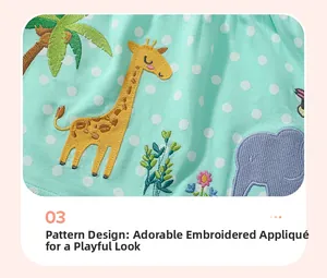 Detail of giraffe and elephant applique embroidery on cotton mint green fabric