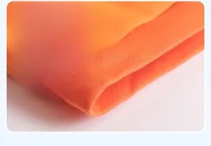 Detailed close-up of the orange ribbed hem design on this thick cotton kids' sweater