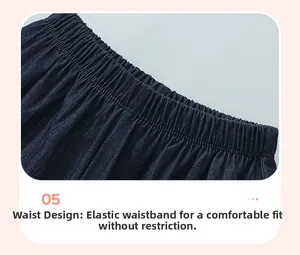 Detailed macro view of the elastic waistband on dark blue denim cotton shorts for girls