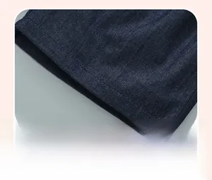 Detailed close-up of double-stitched hem on dark blue cotton denim shorts for girls