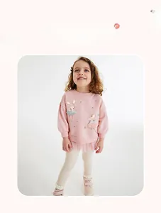 Pink long sleeve sweatshirt with mouse print and tulle hem on a young girl model