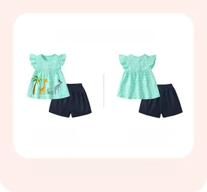 Flat lay of girl's cotton summer set with giraffe print top and navy blue shorts
