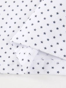 White cotton kids polo shirt with black star print and durable double-stitched hem