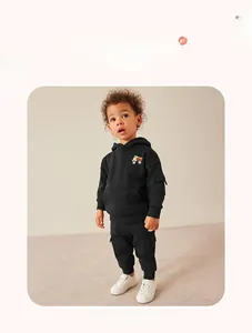Detail of boys' black hooded sweatshirt set with colorful dump truck print and cargo pants