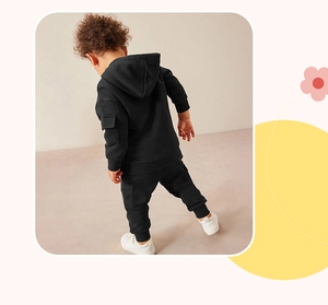 Back view of boys black hooded tracksuit set featuring cargo pockets and cotton fabric