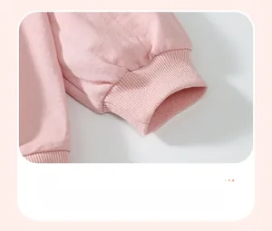 Detail of pink cotton top showing ribbed cuffs and soft high-quality fabric texture