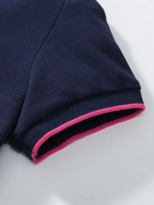 Meisjes katoenen polojurk marineblauw met roze geribbelde manchetten en piqué stof