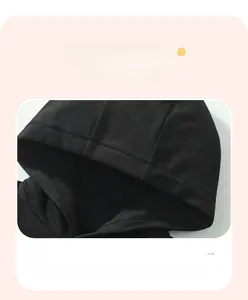 Detailed close-up of hooded design on black cotton knit sweatshirt for boys