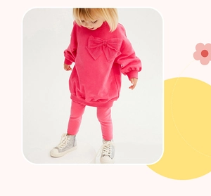 Detail of rose pink girls' sweatshirt set featuring a large bow and knitted cotton fabric