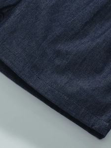 Detail of dark blue denim cotton girls' set showing premium stitching and fabric texture