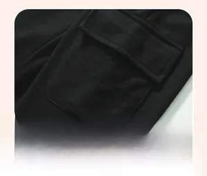 Detailed macro view of the patch pocket on black cotton knit pants for toddler boys