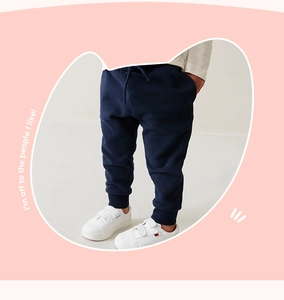 Detail of navy blue cotton joggers for boys with drawstring waist and ribbed ankle cuffs