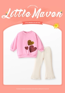 Detail of pink sweatshirt with sequin hearts and cream ribbed bell-bottom pants for girls