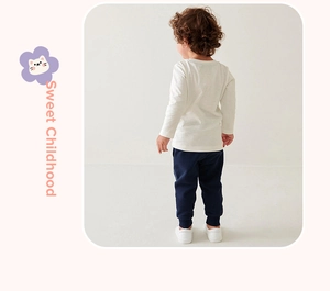 Detail view of boys' long-sleeved white T-shirt and navy joggers from a back perspective