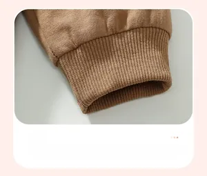 Detailed macro view of the brown ribbed knit cuff on this long-sleeved kids' outfit