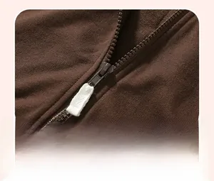 Close-up of baby jacket zipper with fabric puller and detailed knit cotton texture