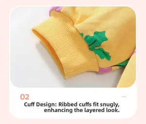 Detail of ribbed cuffs on yellow girl's sweatshirt with leaf and dot patterns