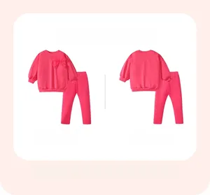 Flat lay view of girls pink sweatshirt set with 3D bow detail and matching leggings