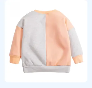 Back view of a cotton-blend kids sweatshirt with grey and pink asymmetrical panel design