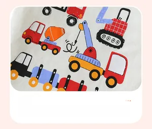 Close-up of boys t-shirt featuring colorful cartoon construction vehicle prints