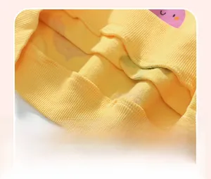 Detail of lemon yellow ribbed hem on a girls' sweatshirt showing elastic knit texture